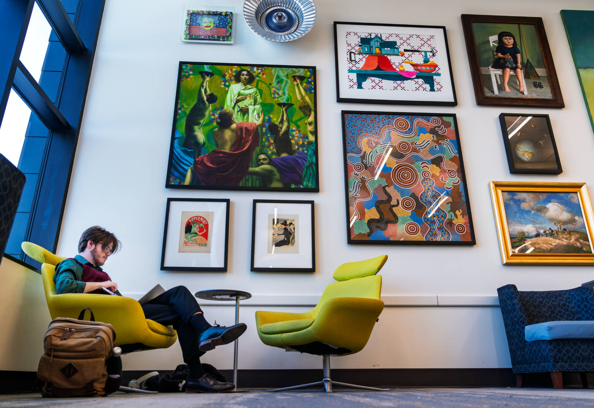 Music major Seamus Adams sits inside the lobby of the Haas Center for Performing Arts on February 10.